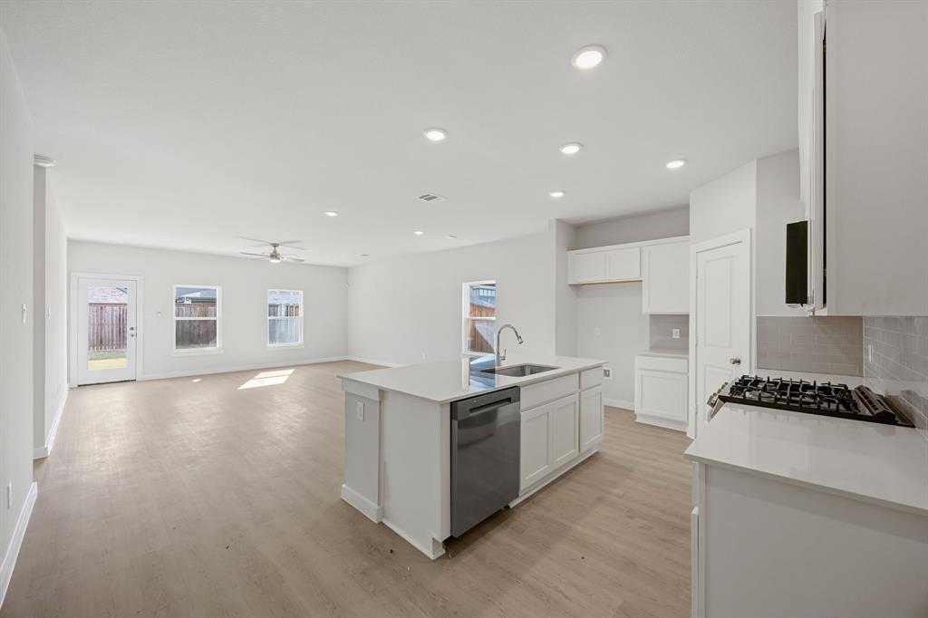 734 Carson Drive Forney, TX 75126 - Photo 4 of 31 a kitchen with stainless steel appliances granite countertop a stove top oven a sink and a refrigerator