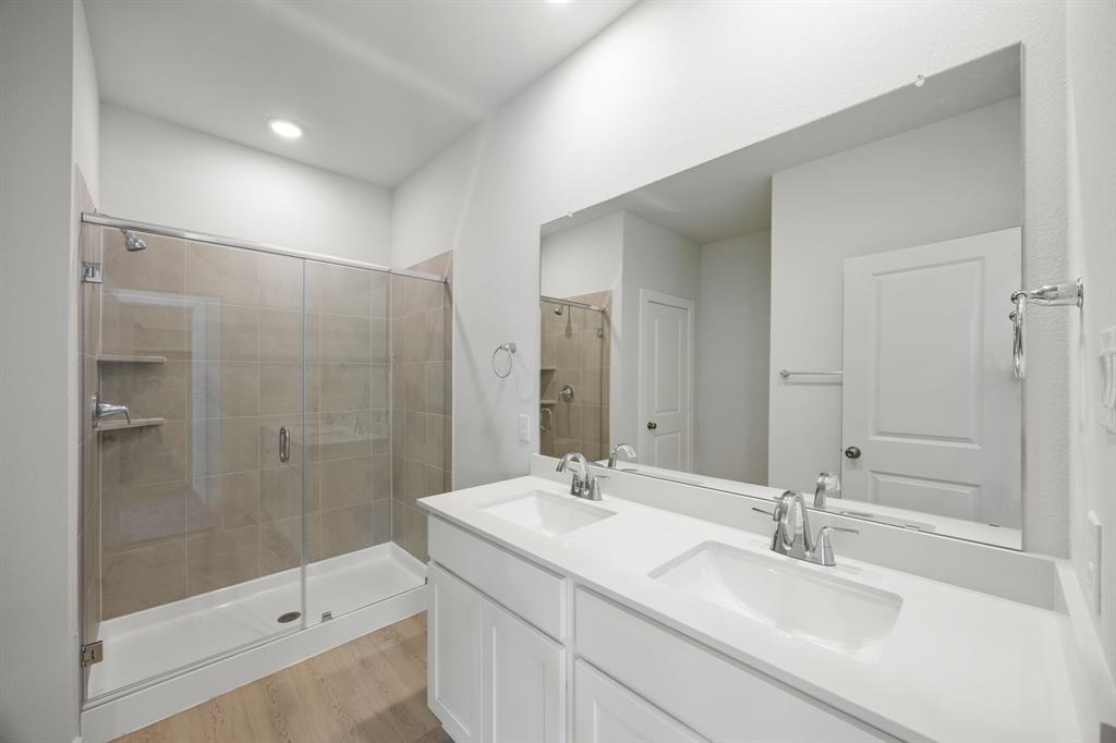 734 Carson Drive Forney, TX 75126 - Photo 7 of 31 a bathroom with a sink shower and a mirror