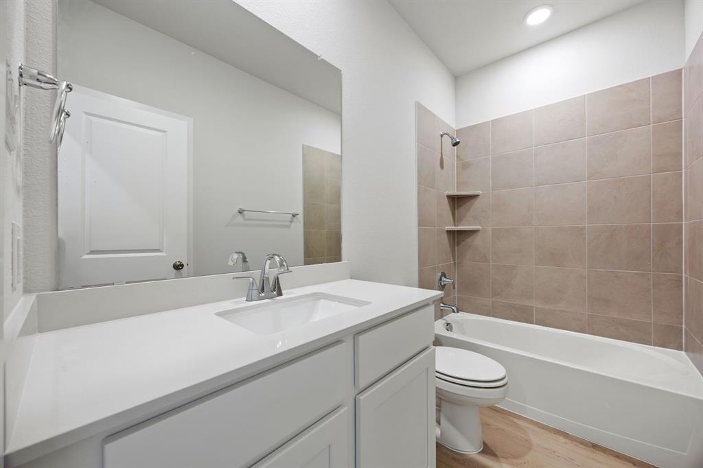 734 Carson Drive Forney, TX 75126 - Photo 9 of 31 a bathroom with a sink a toilet and shower