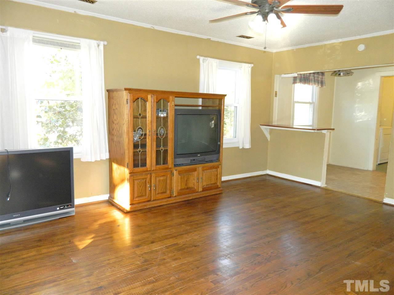 500 Grovemont Road Raleigh, NC 27603 - Photo 3 of 18 a view of an empty room with a window and wooden floor