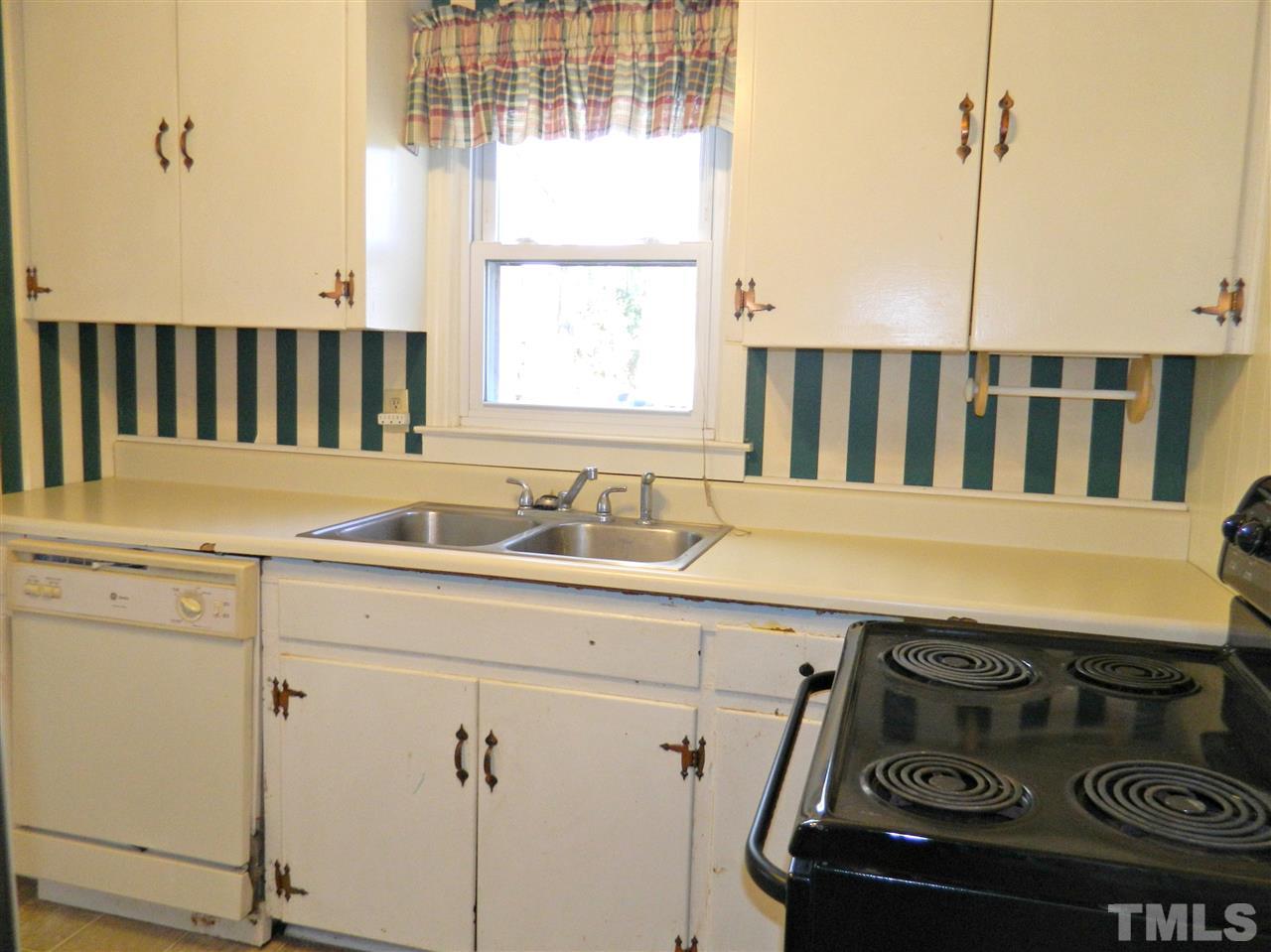 500 Grovemont Road Raleigh, NC 27603 - Photo 6 of 18 a kitchen with a stove a sink and a window