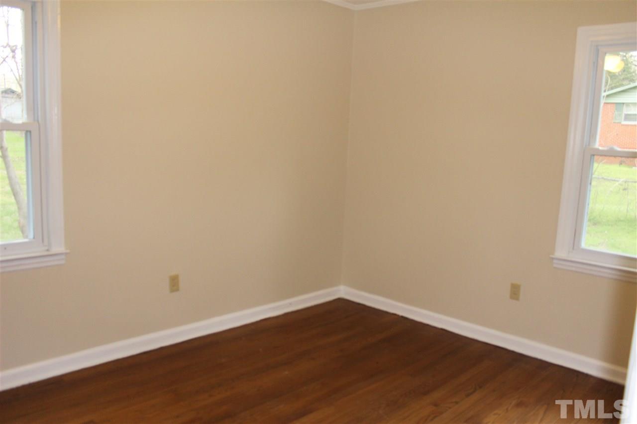 500 Grovemont Road Raleigh, NC 27603 - Photo 9 of 18 an empty room with wooden floor and windows