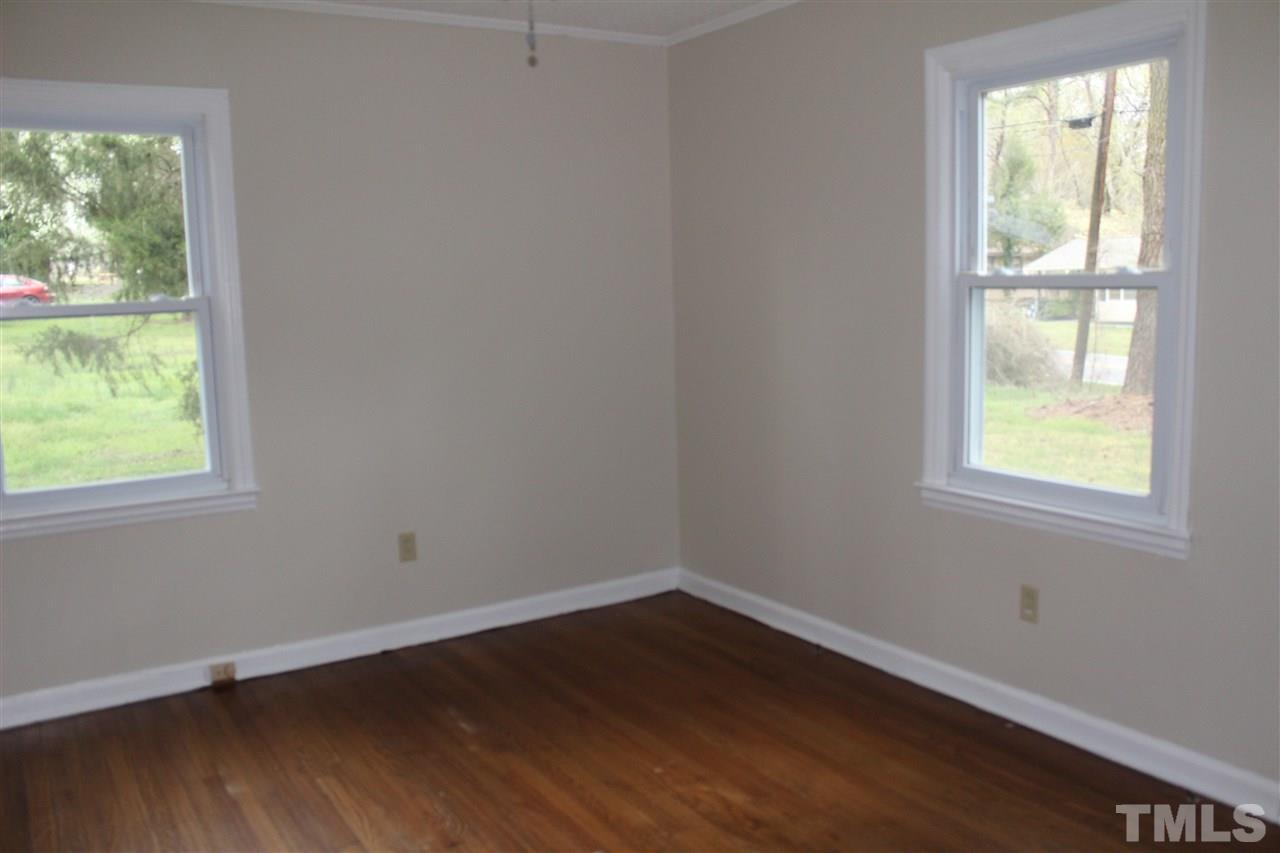500 Grovemont Road Raleigh, NC 27603 - Photo 10 of 18 an empty room with wooden floor and windows
