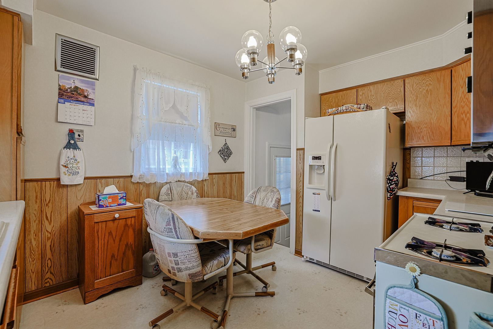 5245 North Rutherford Avenue Chicago, IL 60656 - Photo 8 of 21 a kitchen that has a table chair and stainless steel appliances