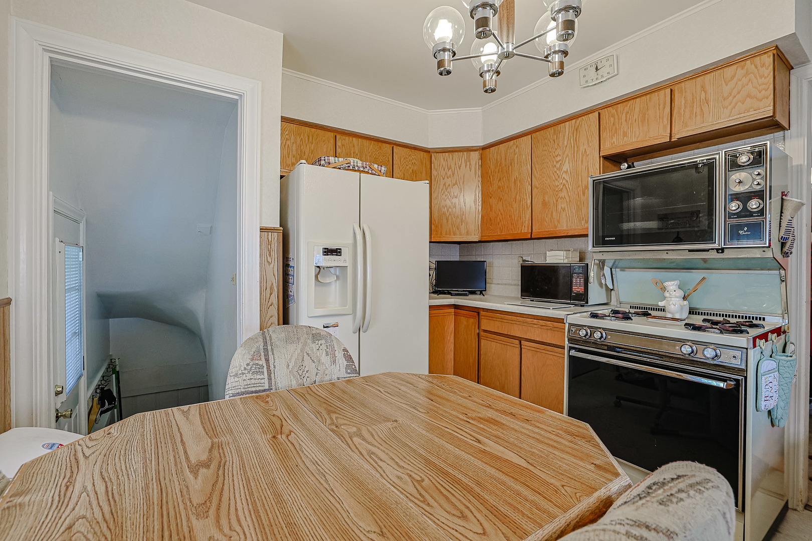 5245 North Rutherford Avenue Chicago, IL 60656 - Photo 10 of 21 a kitchen with a stove a sink and a refrigerator