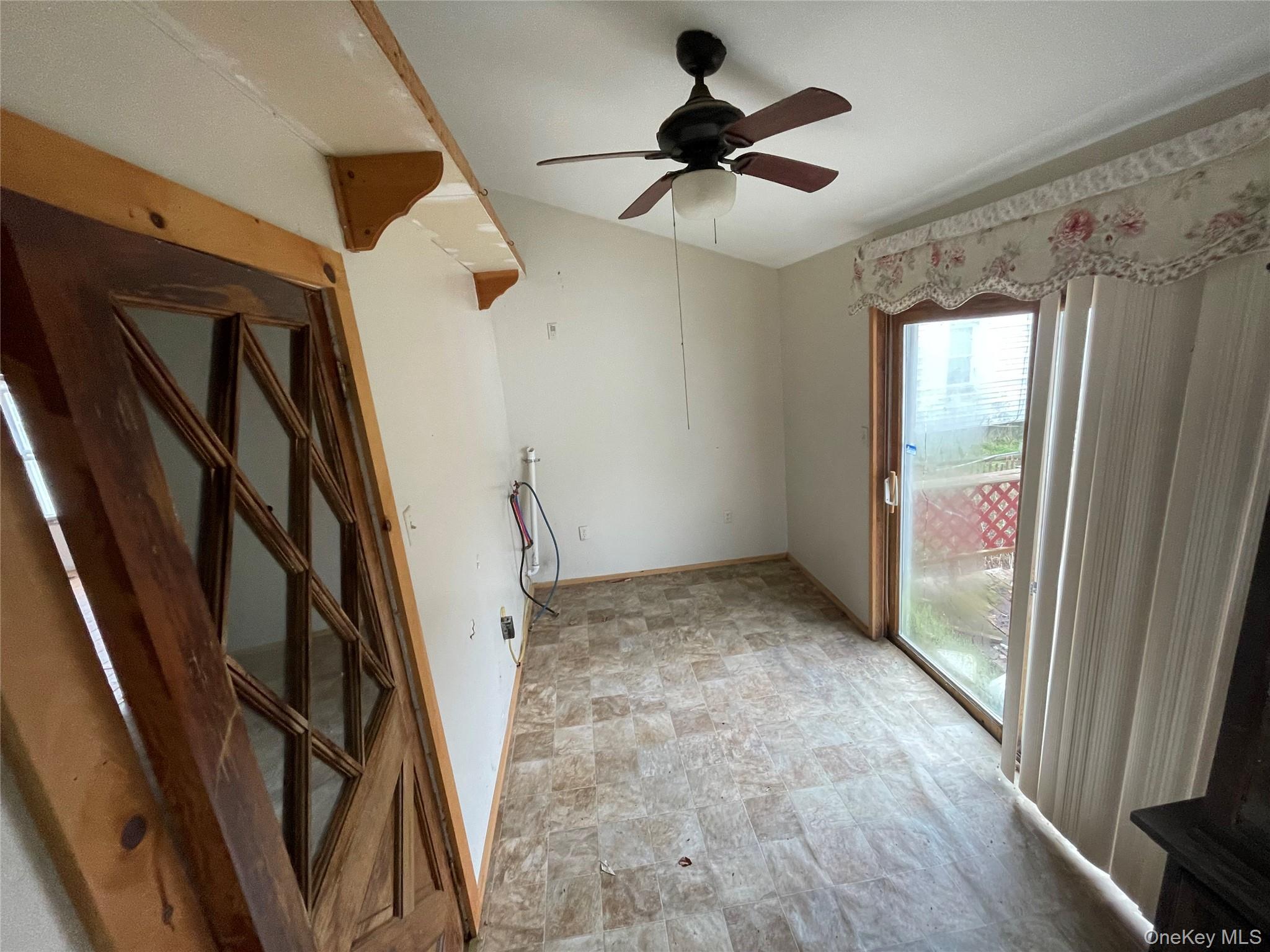 865 North Branch Road Callicoon, NY 12766 - Photo 5 of 15 Unfurnished room with ceiling fan and stone finish flooring