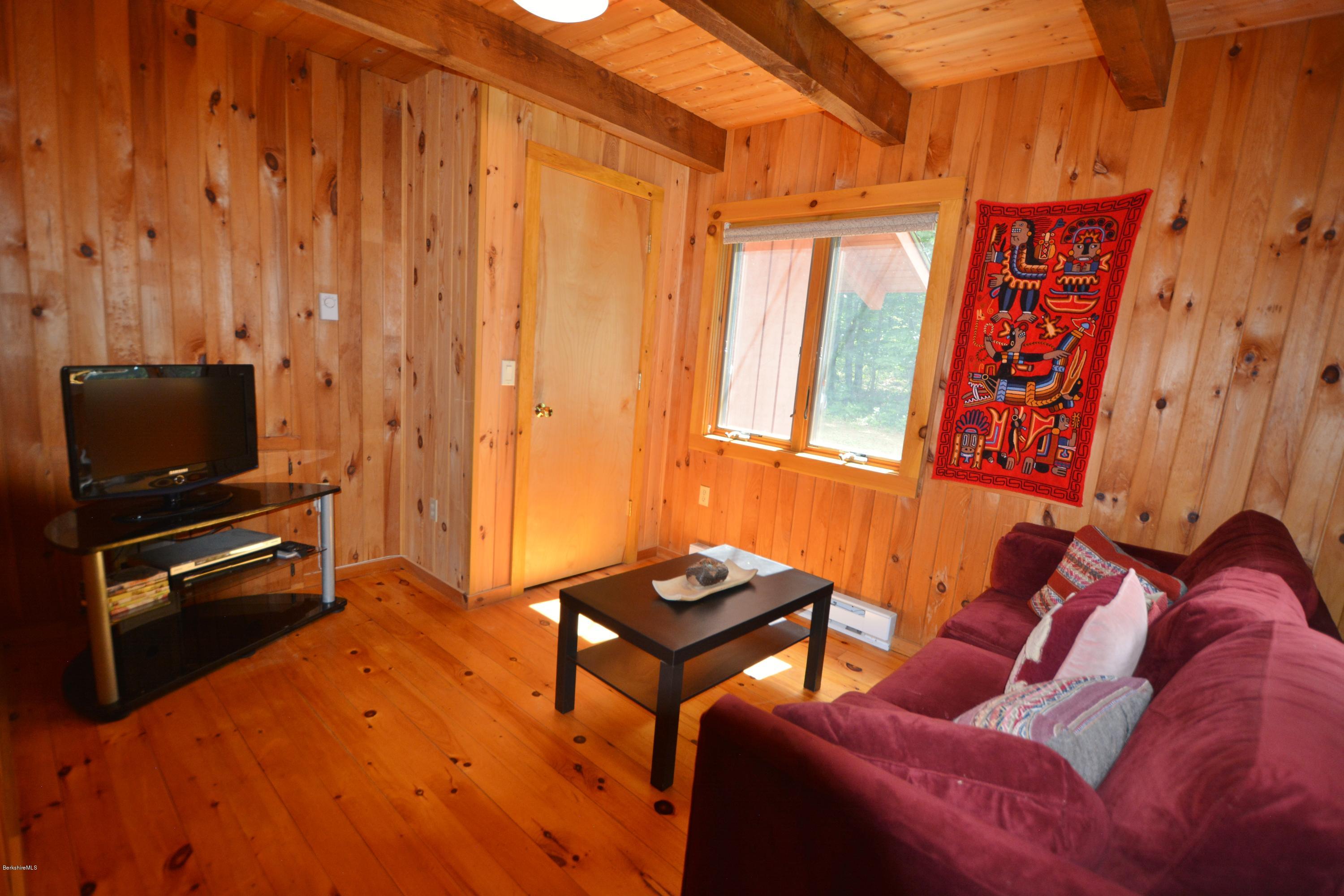 395 Bonny Rigg Hill Road Becket, MA 01223 - Photo 11 of 26 a living room with furniture a flat screen tv and a window
