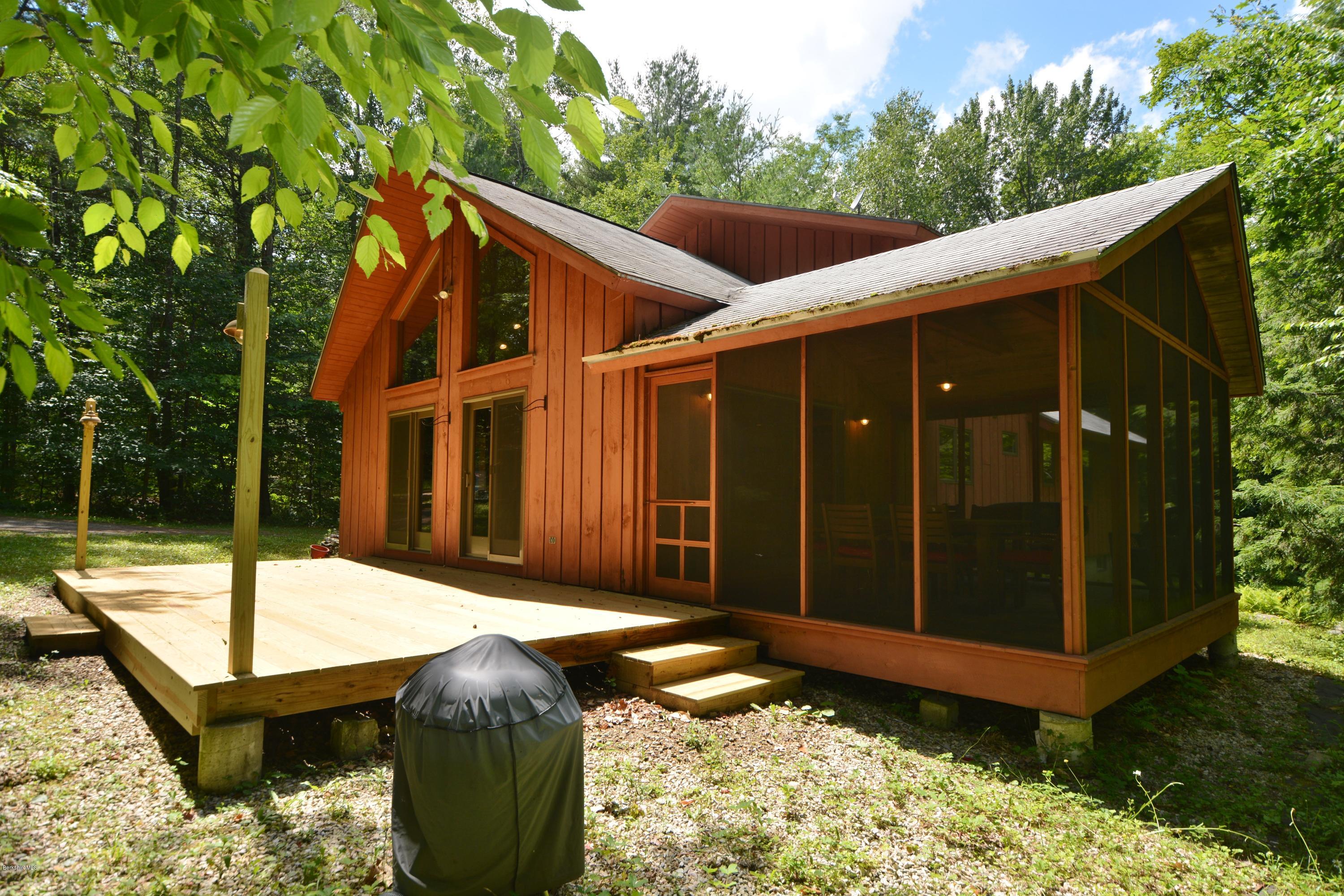 395 Bonny Rigg Hill Road Becket, MA 01223 - Photo 16 of 26 a backyard of a house with table and chairs