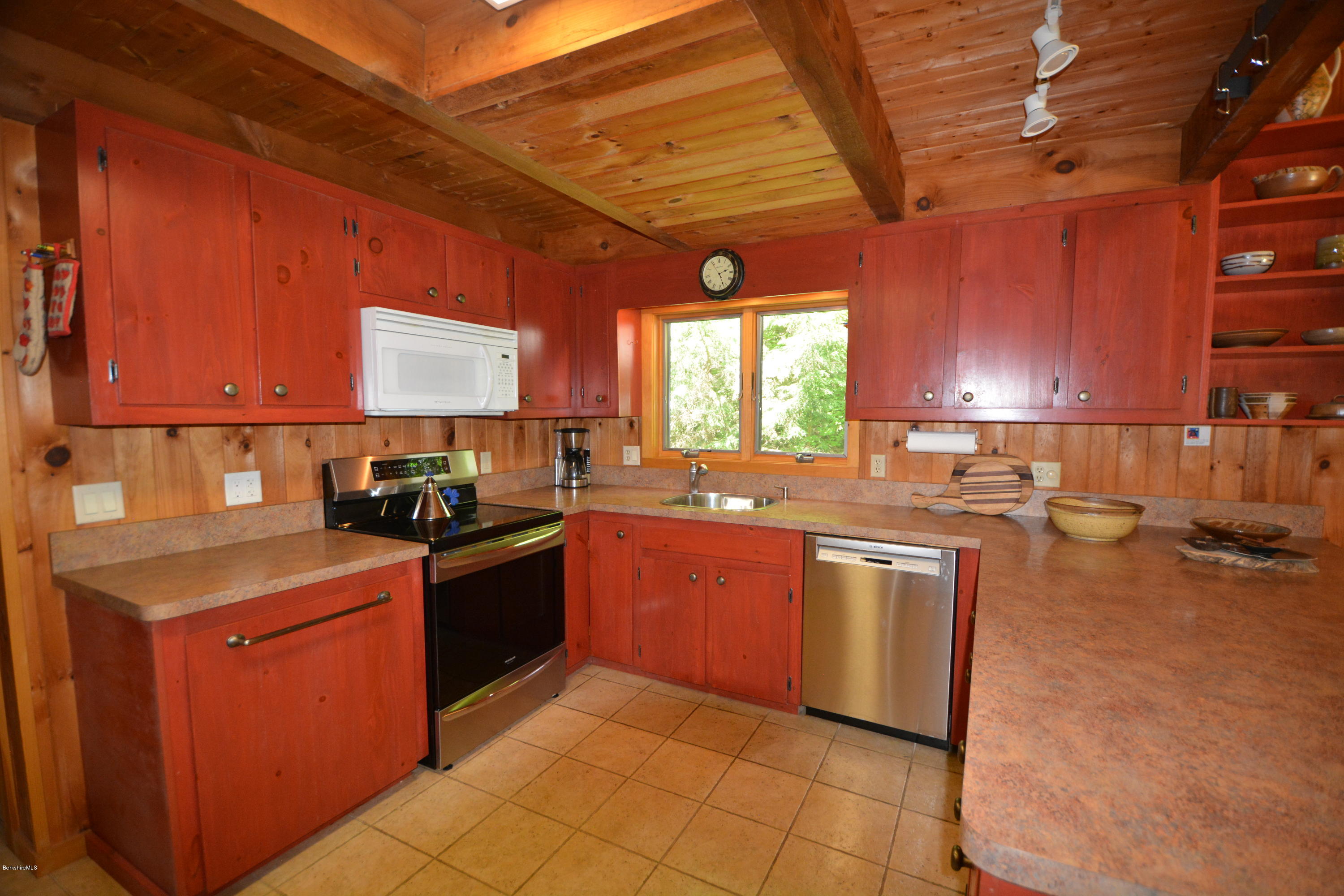 395 Bonny Rigg Hill Road Becket, MA 01223 - Photo 7 of 26 a kitchen with stainless steel appliances granite countertop wooden cabinets a stove top oven a sink and dishwasher