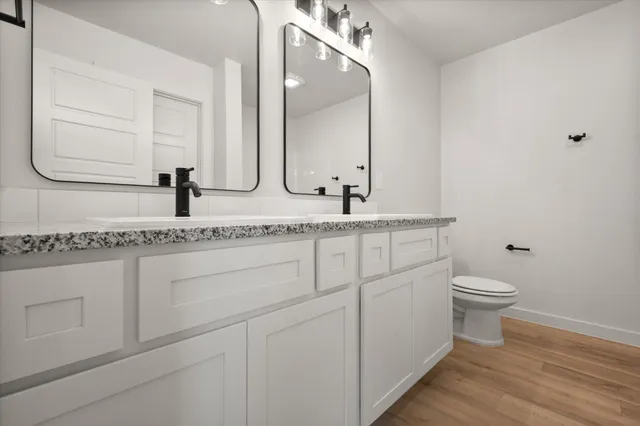 a bathroom with a granite countertop sink and a mirror