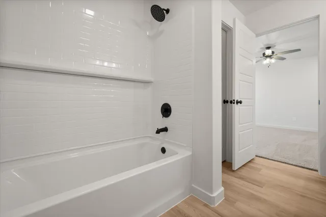 a bathroom with a bathtub and shower