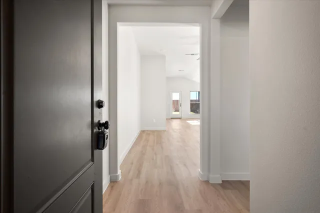 a view of a room with wooden floor and a bathroom