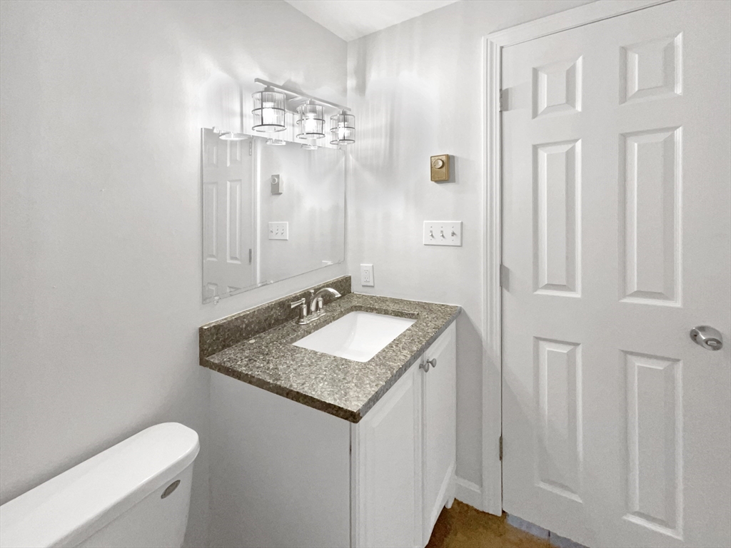 30 Manhattan Road Worcester, MA 01602 - Photo 16 of 27 a bathroom with a granite countertop sink and a mirror