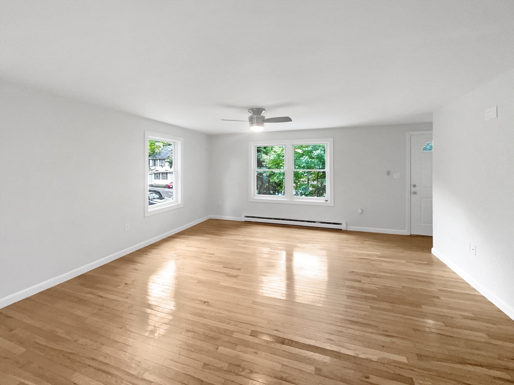 30 Manhattan Road Worcester, MA 01602 - Photo 3 of 27 an empty room with wooden floor and windows