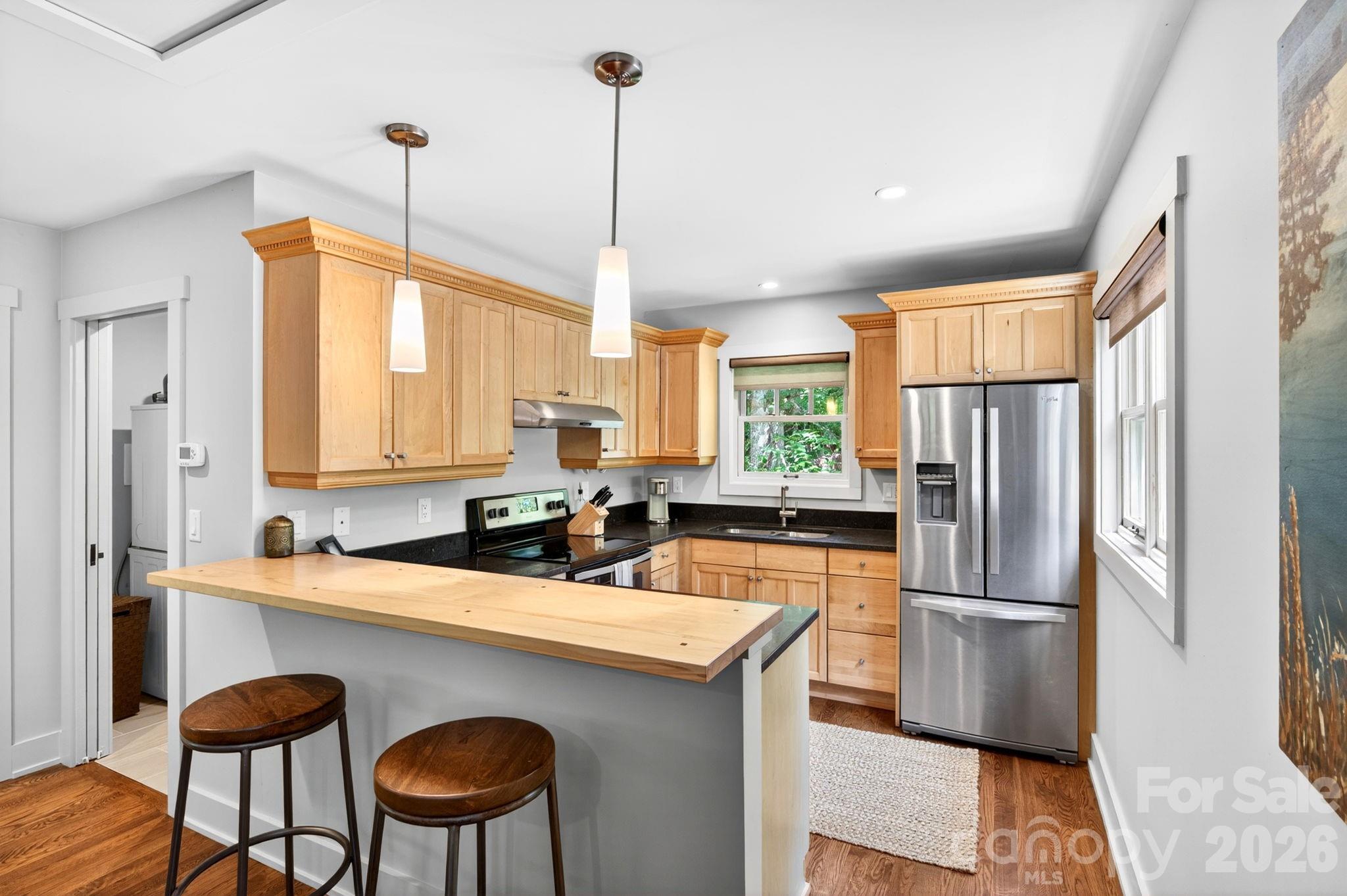 235 Bull Creek Road Asheville, NC 28805 - Photo 39 of 47 a kitchen with stainless steel appliances granite countertop a refrigerator a sink a stove and chairs