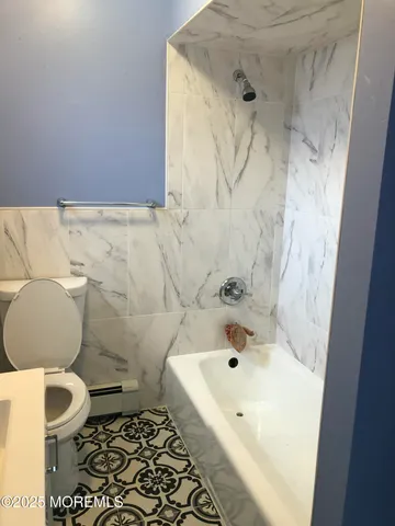 a bathroom with a bathtub and a toilet