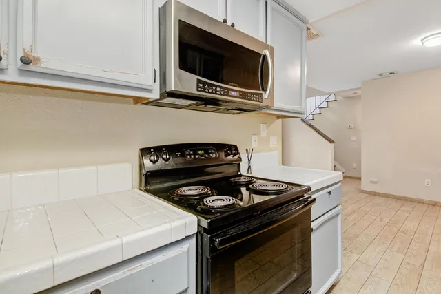 a stove top oven sitting inside of a kitchen