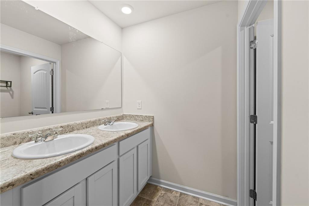 297 Starbuck Parkway Pendergrass, GA 30567 - Photo 13 of 50 a bathroom with a granite countertop sink and a mirror