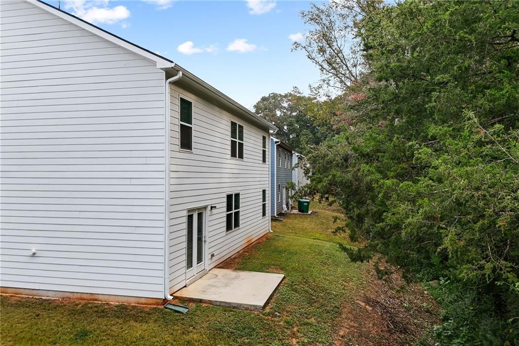 297 Starbuck Parkway Pendergrass, GA 30567 - Photo 14 of 50 a backyard of a house with table and chairs
