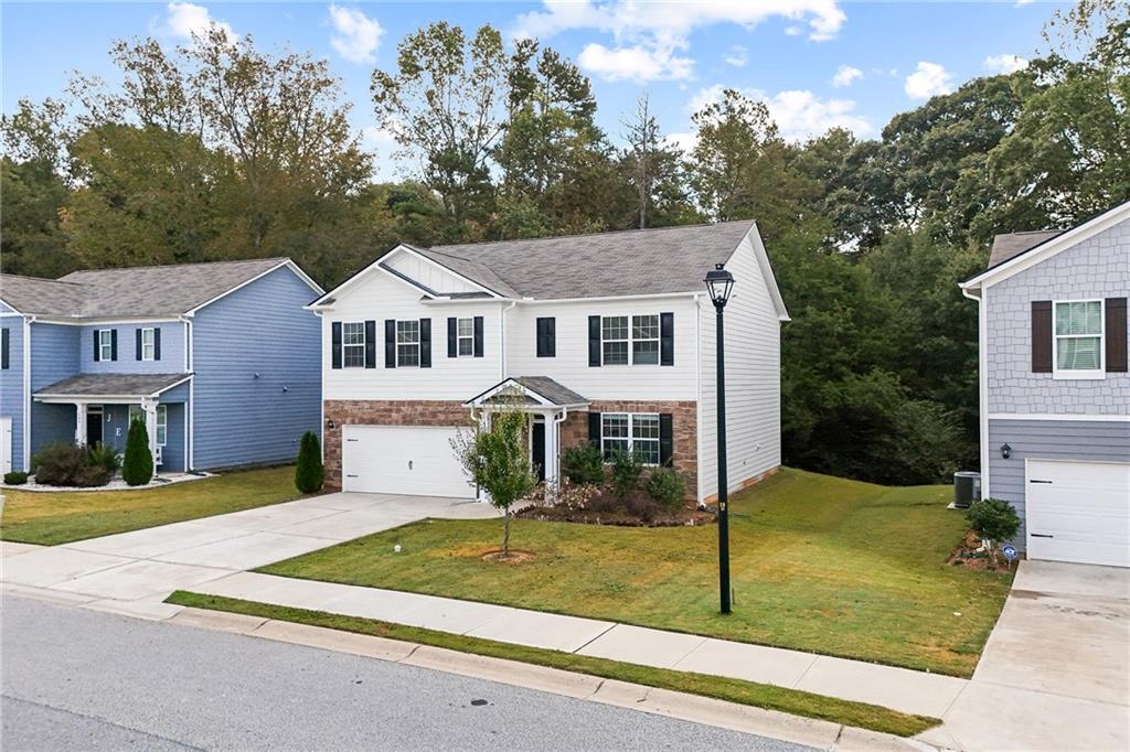 297 Starbuck Parkway Pendergrass, GA 30567 - Photo 18 of 50 a front view of a house with garden