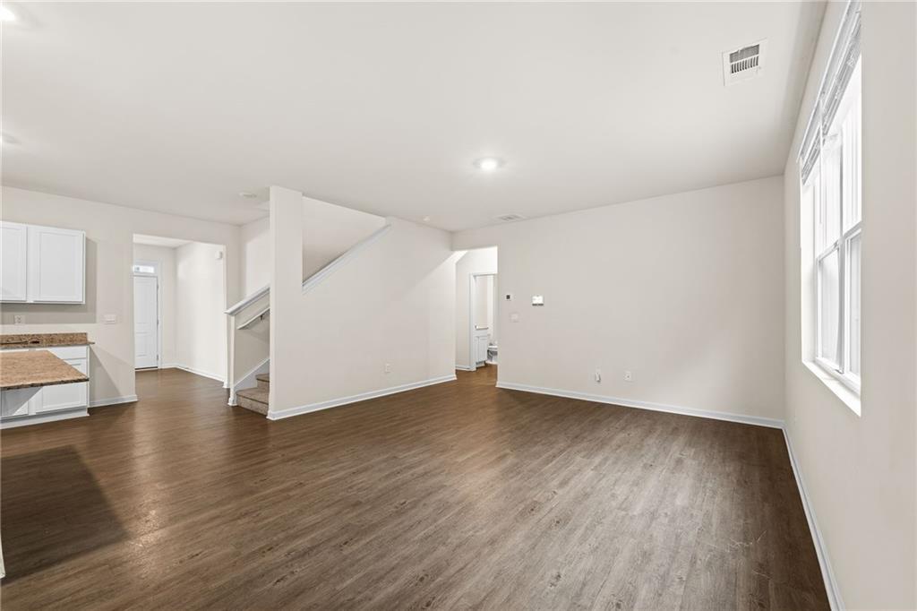 297 Starbuck Parkway Pendergrass, GA 30567 - Photo 26 of 50 an empty room with wooden floor and windows
