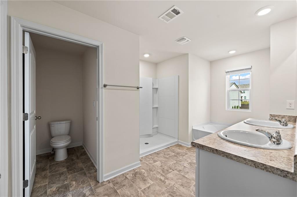 297 Starbuck Parkway Pendergrass, GA 30567 - Photo 32 of 50 a bathroom with a granite countertop sink toilet and shower