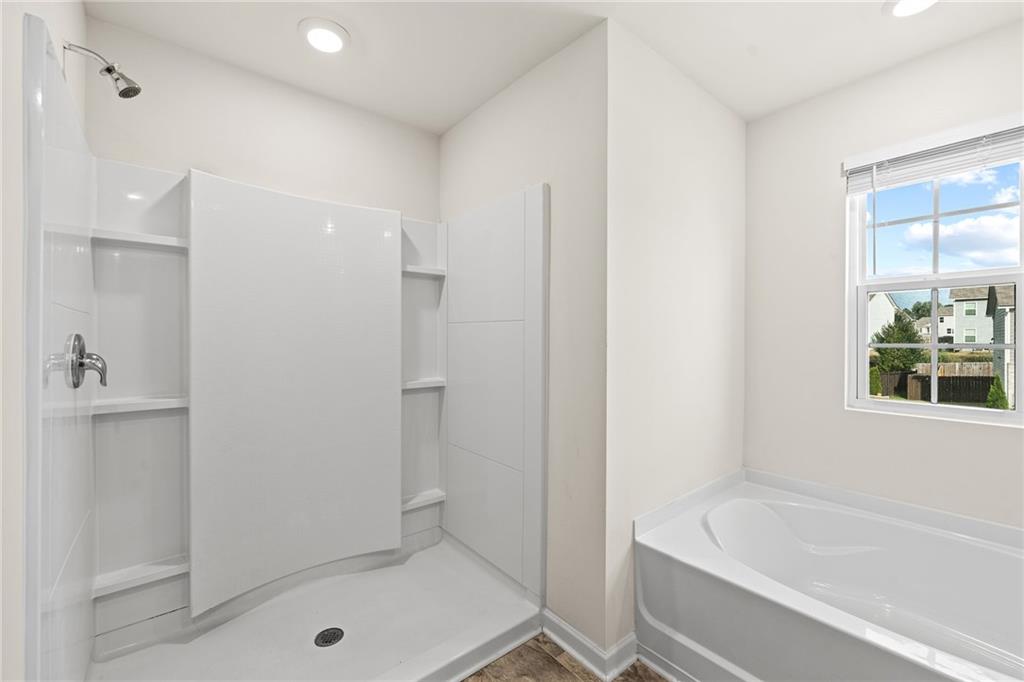 297 Starbuck Parkway Pendergrass, GA 30567 - Photo 34 of 50 a bathroom with a tub shower and a sink