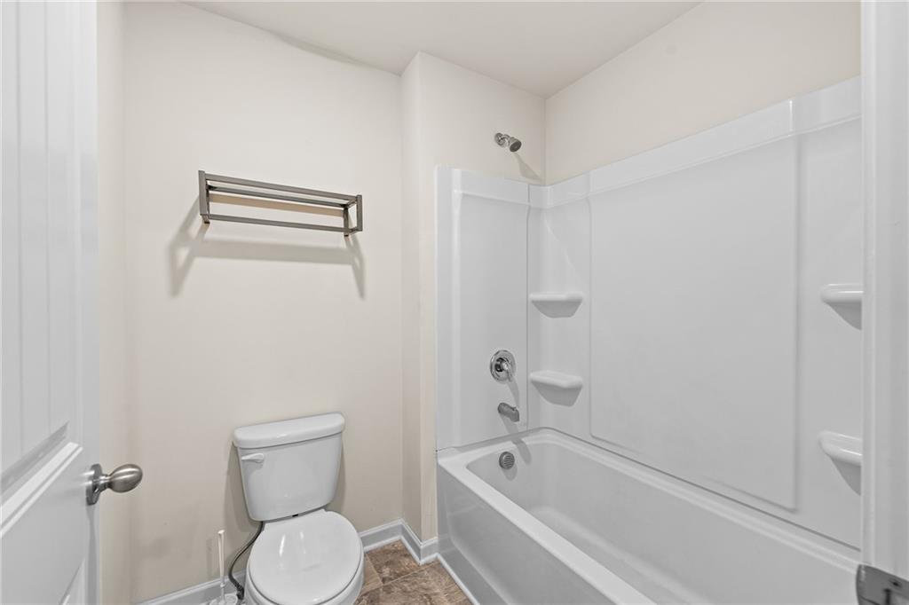 297 Starbuck Parkway Pendergrass, GA 30567 - Photo 40 of 50 a bathroom with a toilet and a tub