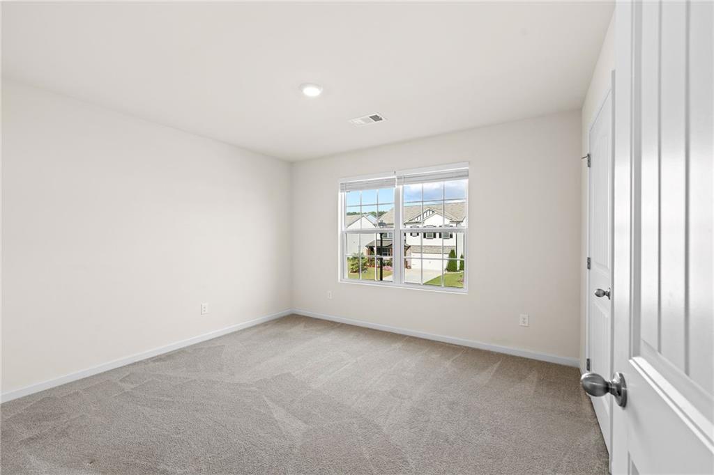 297 Starbuck Parkway Pendergrass, GA 30567 - Photo 41 of 50 an empty room with windows