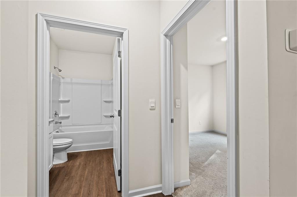297 Starbuck Parkway Pendergrass, GA 30567 - Photo 9 of 50 a bathroom view of a toilet and a mirror