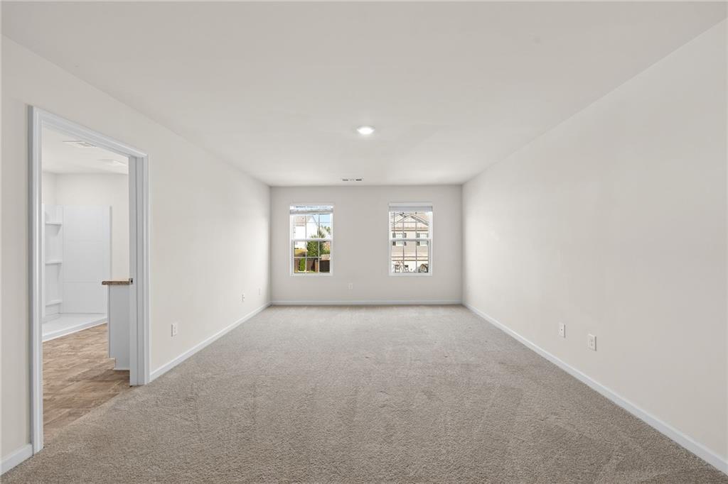297 Starbuck Parkway Pendergrass, GA 30567 - Photo 10 of 50 an empty room with windows and mirror