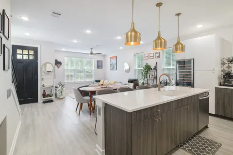 a view of kitchen island a sink and living room view