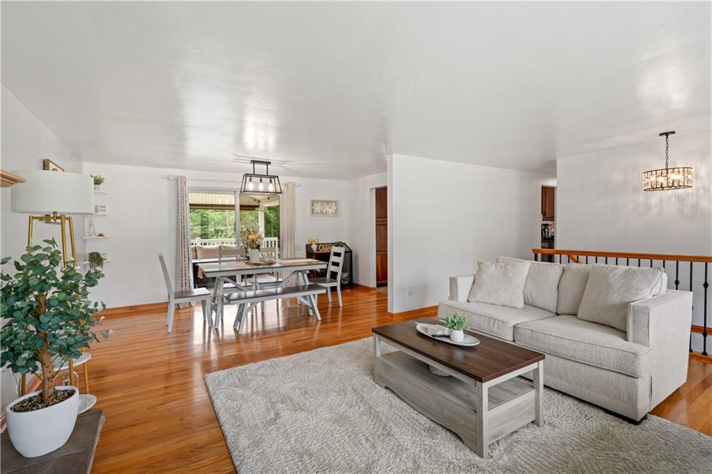 Open Concept with access to the Living Room/ Dining Room and Kitchen. Sling doors open up to the beautiful Deck with partial Roof and other side open.