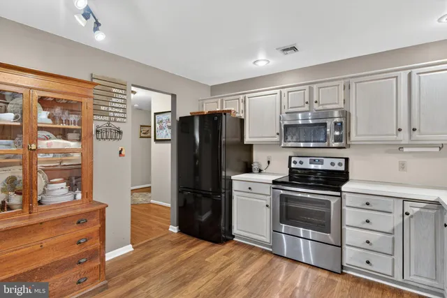a kitchen with stainless steel appliances a refrigerator stove and sink