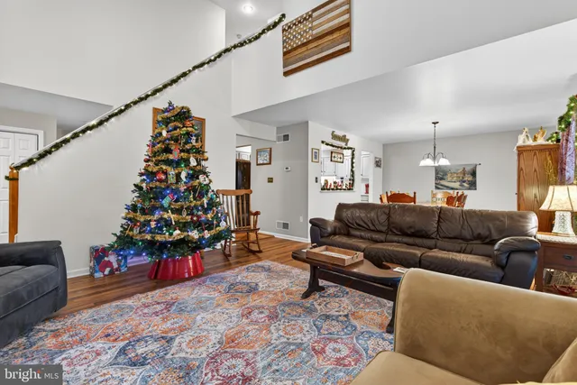 a living room with lots of flowers and a couch