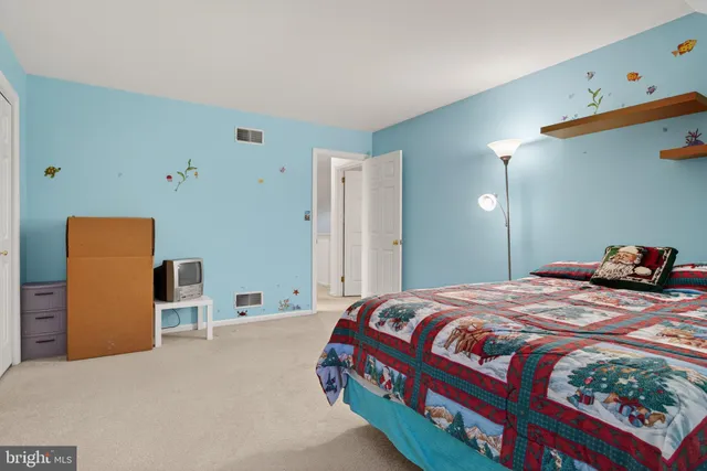 a bedroom with a bed and dresser