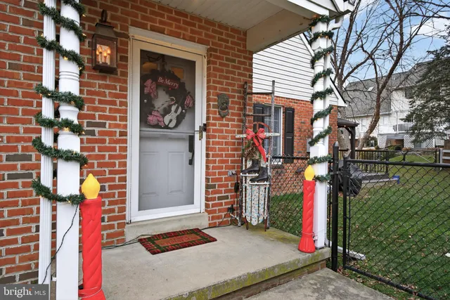 a view of a house with a wooden fence