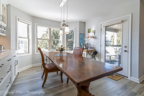a dining room with furniture a chandelier and wooden floor
