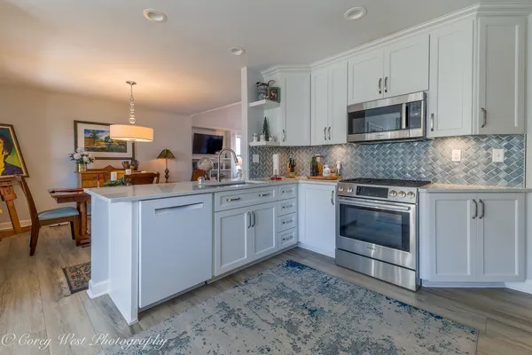 a kitchen with a sink stove and microwave