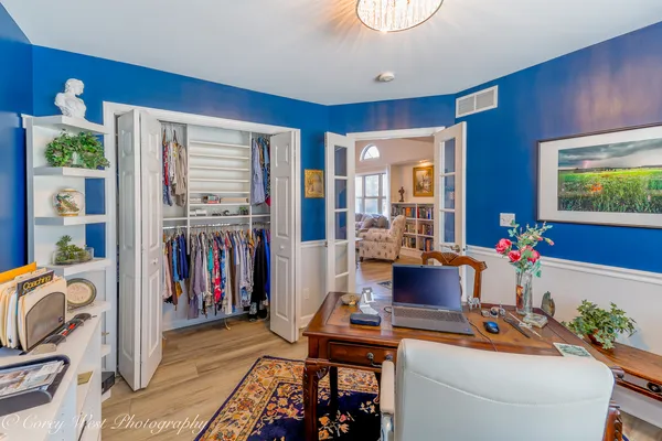 a view of walk in closet with clothes and shoes