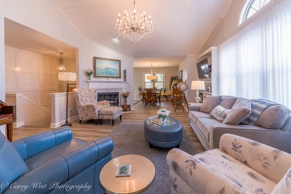 a living room with furniture a fireplace and a window