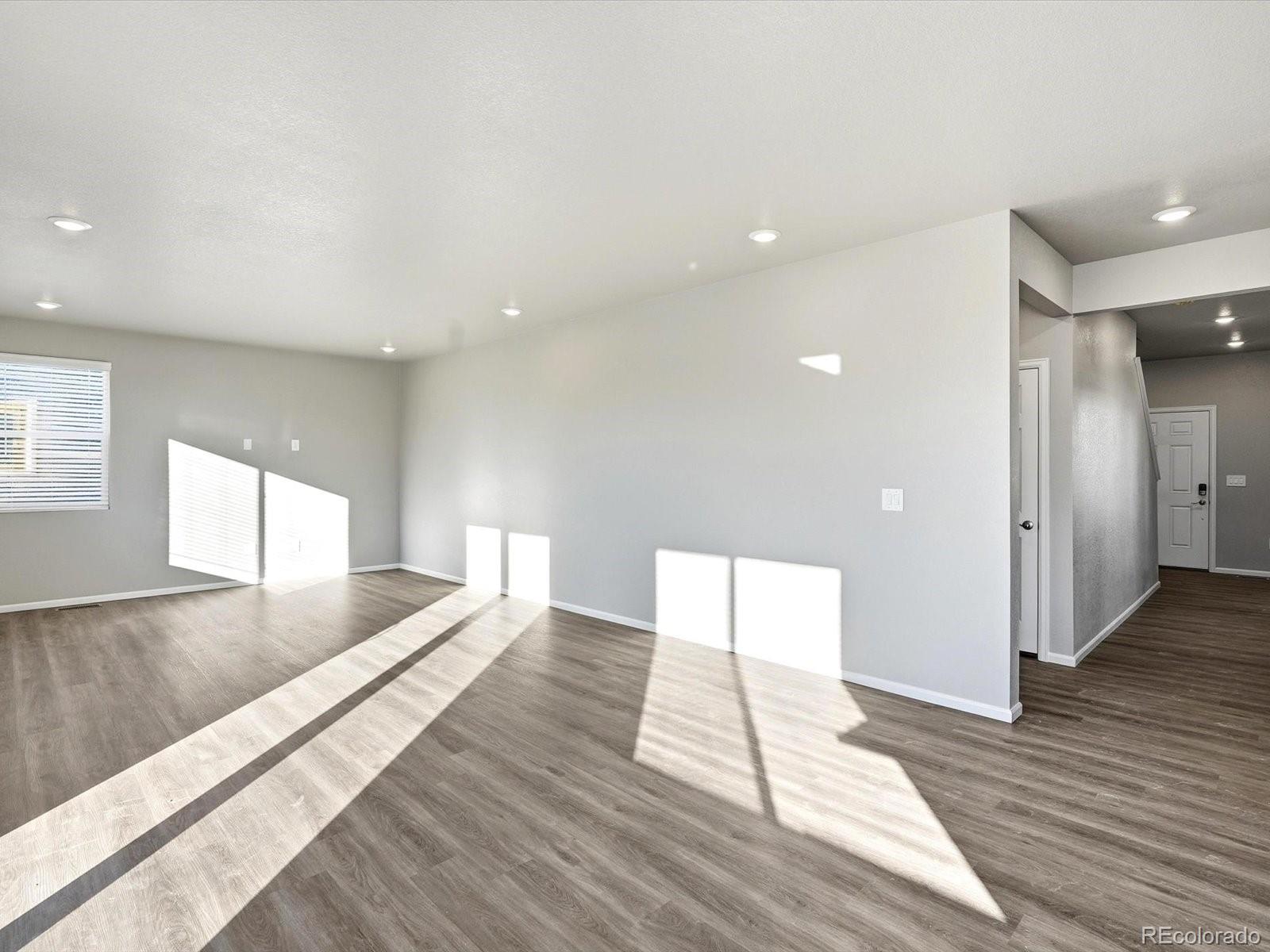 7317 West 27th St Road Greeley, CO 80634 - Photo 5 of 28 a view of an empty room with wooden floor and a window