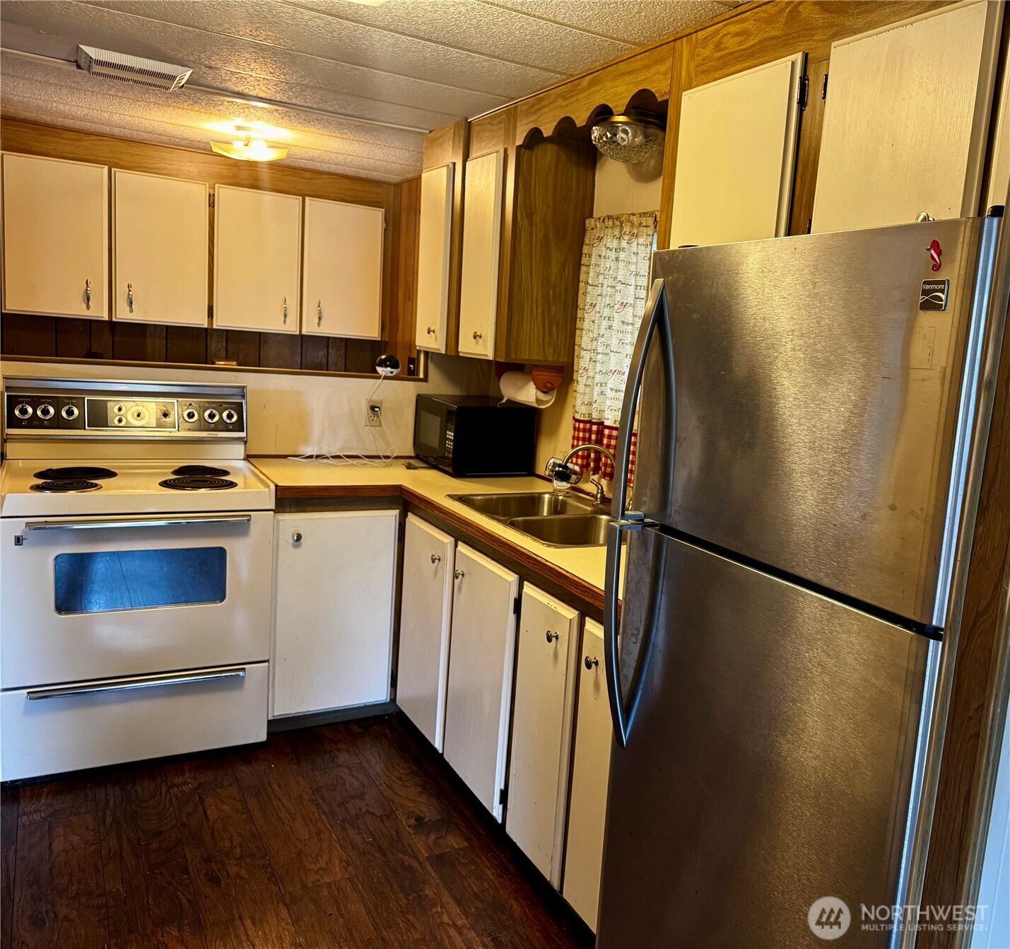 20501 31st Drive Southeast Bothell, WA 98012 - Photo 5 of 11 a kitchen with a refrigerator a sink and cabinets