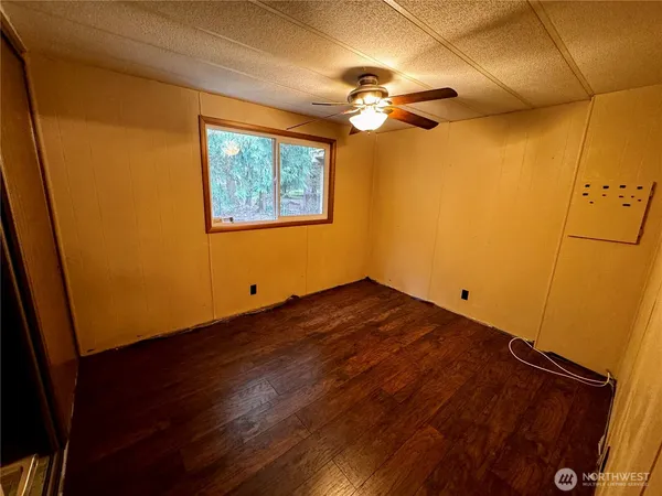 a view of a room with wooden floor and chandelier