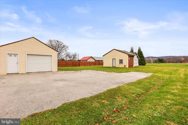 a view of a house with a yard and garage