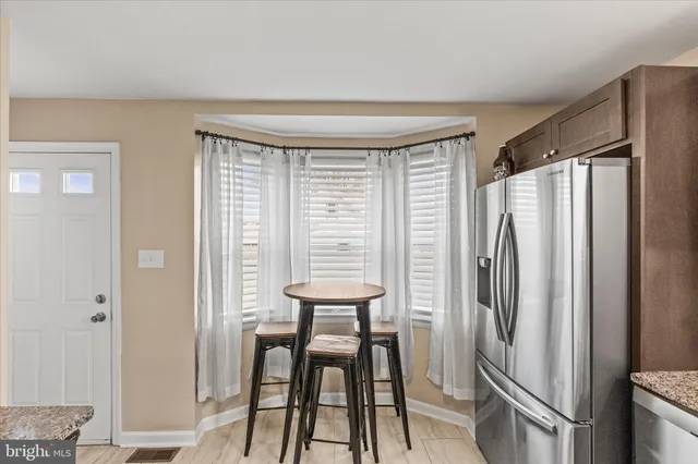 a kitchen with stainless steel appliances a refrigerator and a table