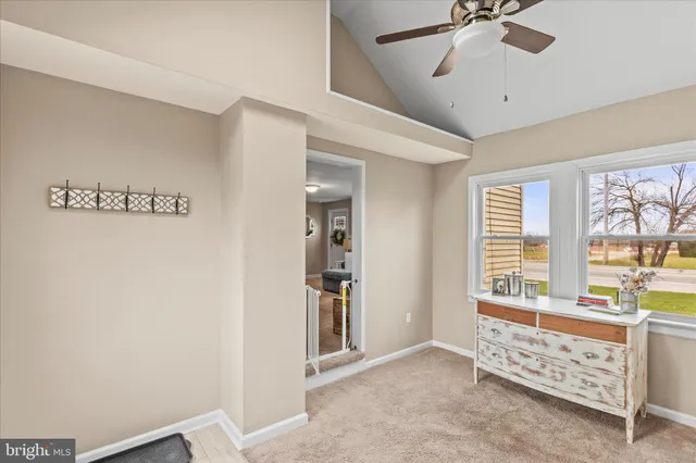 a living room with furniture and a mirror