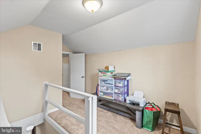 a bedroom with a bed and a lamp on the table