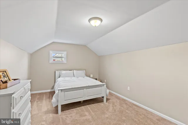 a bedroom with a bed and a desk
