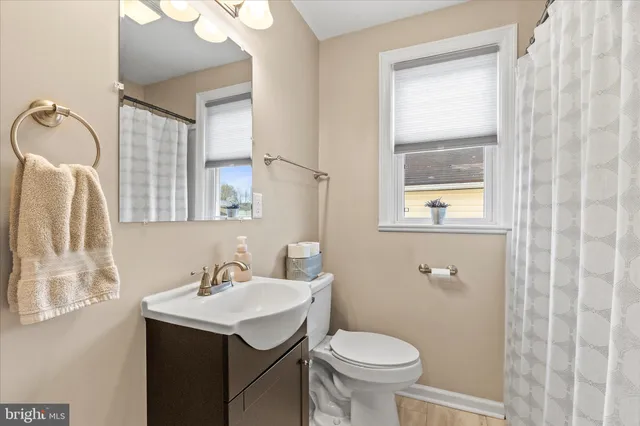 a bedroom with a bed and a flat screen tv on the dresser
